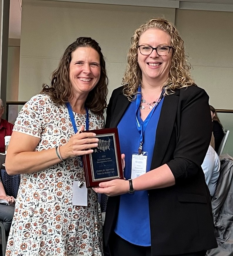 Kristin Paulson receiving an award from Leanne Candura