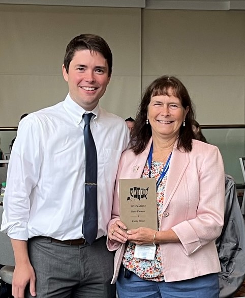 Kathy Hines receiving an award from Kevin McAvey