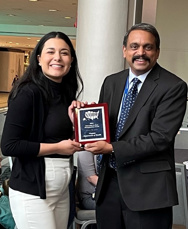Anup Srikumar receiving an award from Nicole Fawcett